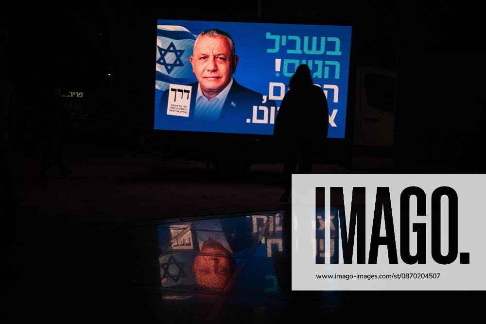 Be er Sheva, New York, Israel: A person walks by a sign bearing the likeness of GADI EISENKOT the leading candidate to replace PM Benjamin Netanyahu in the upcoming Israeli elections, at a campaign rally of his party Yashar in Beâ€⠢er Sheva. Be er Sheva Israel - ZUMAg280 20261020_znp_g280_003