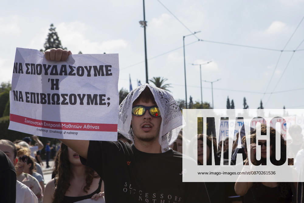 Athens Greece Living Costs Protest A protester holds a placard reading Should We Study or Survive during a rally in Athens, Greece on October 21, 2026. Students and other demonstrators marched through central Athens to protest rising living costs and economic pressures. Organizers say the concerns raised by participants echo grievances voiced during recent demonstrations in France. Athens Attica Greece