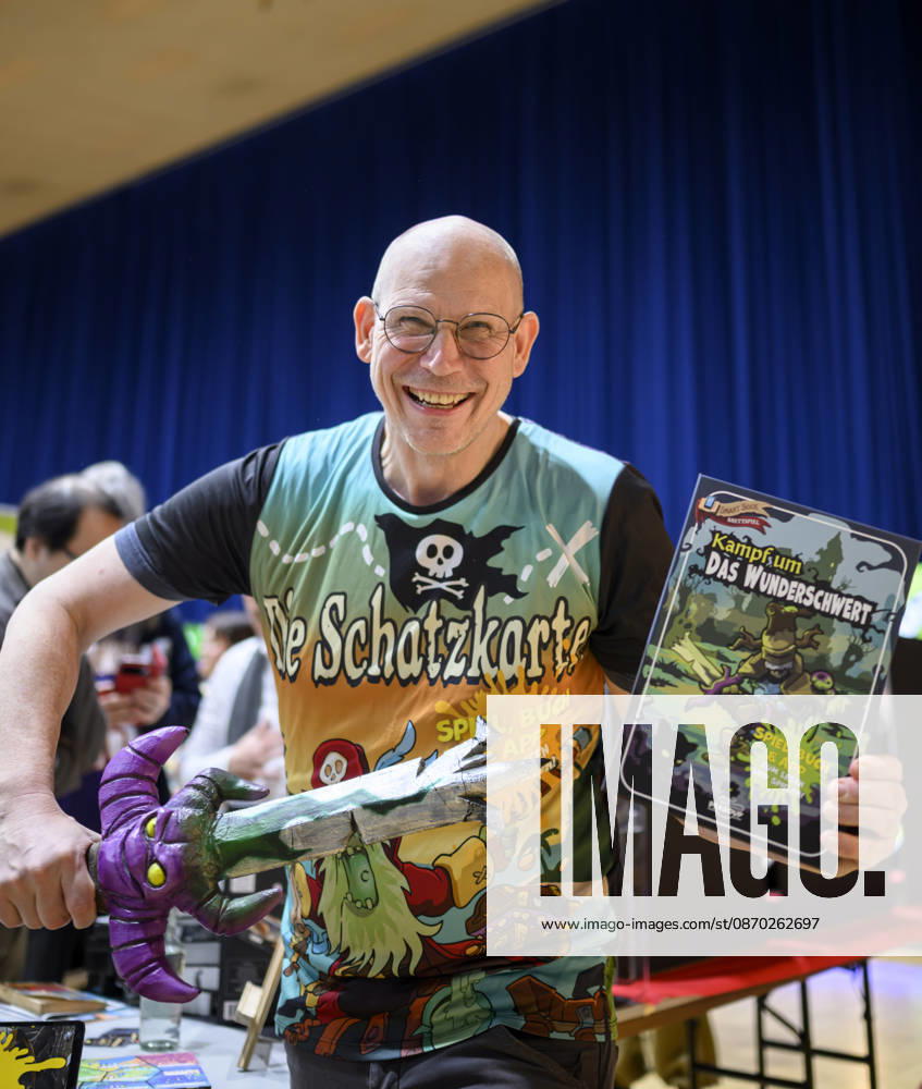 Ein Mitarbeiter präsentiert das Spiel - Kampf um das Wunderschwert - von Peasoup (Dänemark), 3-in-1 Spiel, Gamebook, Brettspiel und interaktive App in einem, Neuheitenschau, am 21.10.2026 Messe SPIEL Essen vom 22.10 - 25.10.2026 in E s s e n Deutschland. Grugahalle