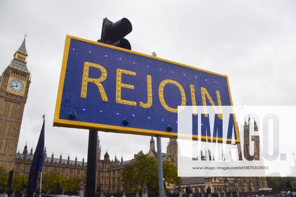 #2 Anti-Brexit and Pro-EU Protest in London, UK - 21 Oct 2026 A Rejoin placard is seen during the weekly anti-Brexit and pro-EU protest in Parliament Square. London United Kingdom