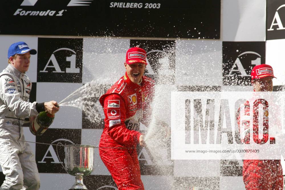 Champagnerdusche während der Siegerehrung beim GP von Österreich 2003: V.li.: Kimi Räikkönen (Finnland McLaren-Mercedes, Michael Schumacher (Deutschland) und Rubens Barrichello (Brasilien beide Ferrari) Motorsport Grand Prix Herren Großer Preis von Österreich 2003, Formel 1 Weltmeisterschaft, F1, F, GP, WM, Vdig Gruppe A1-Ring Zeltweg-Spielberg Begeisterung, Freude,