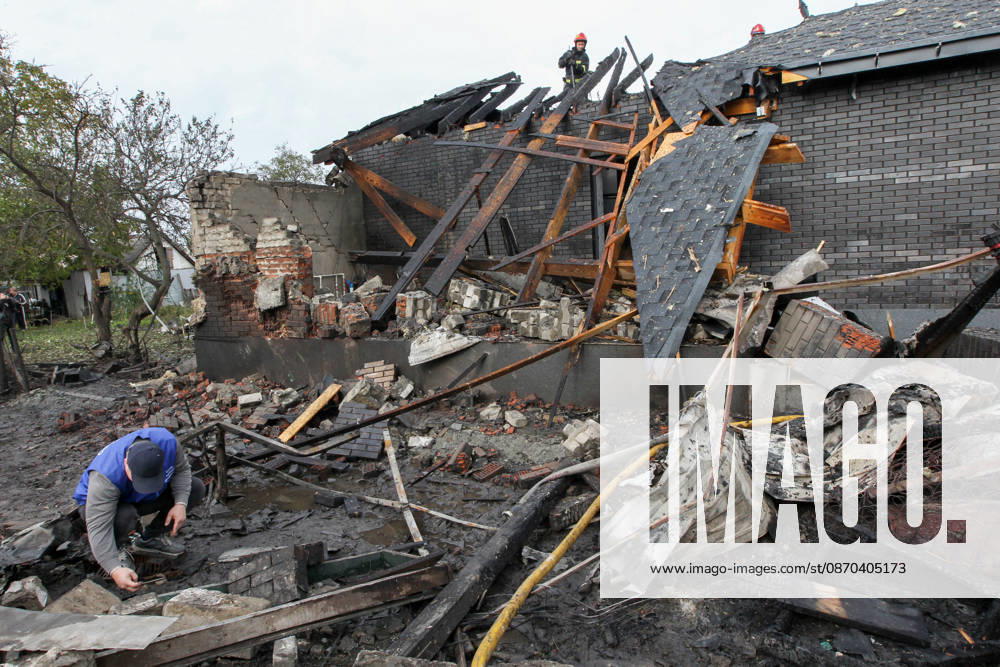 A man explores the ruins as rescuers work during a response effort to a Russian attack on a residential area in Dnipro, Ukraine, October 22, 2026. According to city head Borys Filatov, 11 private houses were damaged in the strike on Thursday morning, and one home burned down completely. (Photo by Mykola Miakshykov Ukrinform) Russian army attacks residential area in Dnipro