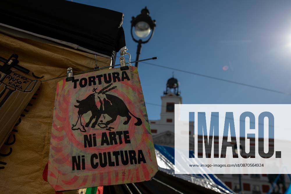 A banner featuring the phrase torture neither art nor culture and an image of a bull can be seen at Puerta del Sol..Tents remain set up by housing rights activists, who organized the occupation of the square in response to the eviction of Maricarmen a woman in her eighties from her home, carried out by a real estate investment fund. Madrid Spain - ZUMAs197 20261023_aaa_s197_155