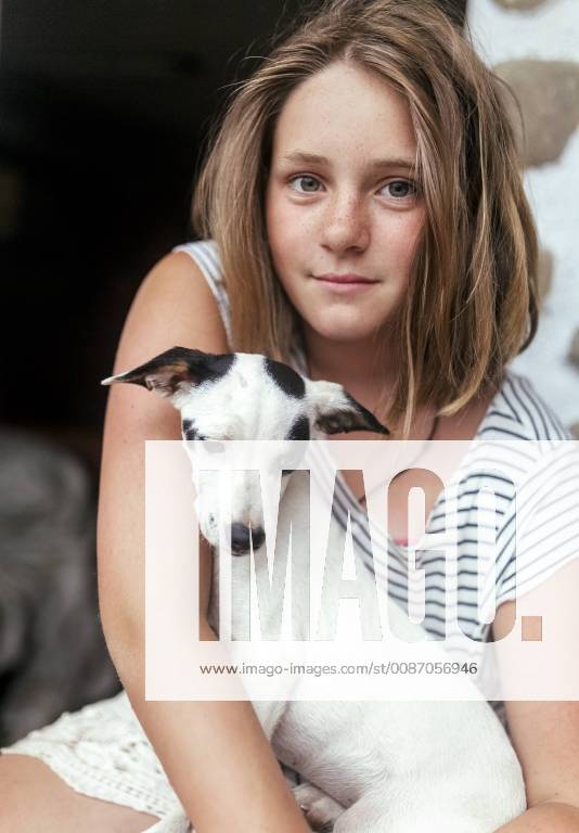 Portrait of freckled girl with puppy on her lap model released Symbolfoto property released MGOF03768