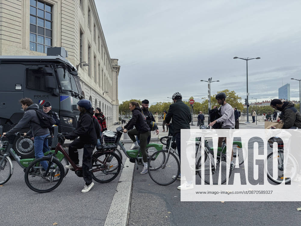 Lyon France Anti-Government Protest Cyclists are questioned by police officers beside a police vehicle in Lyon, France, on October 24, 2026. Police maintained a presence in Lyon as authorities restricted gatherings in parts of the city following unrest during demonstrations the previous weekend. Lyon Rhone Alpes France