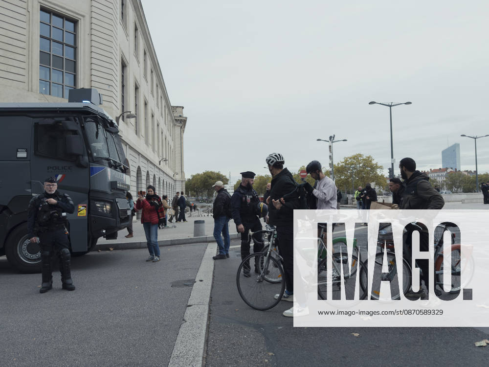 Lyon France Anti-Government Protest Cyclists are questioned by police officers beside a police vehicle in Lyon, France, on October 24, 2026. Police maintained a presence in Lyon as authorities restricted gatherings in parts of the city following unrest during demonstrations the previous weekend. Lyon Rhone Alpes France