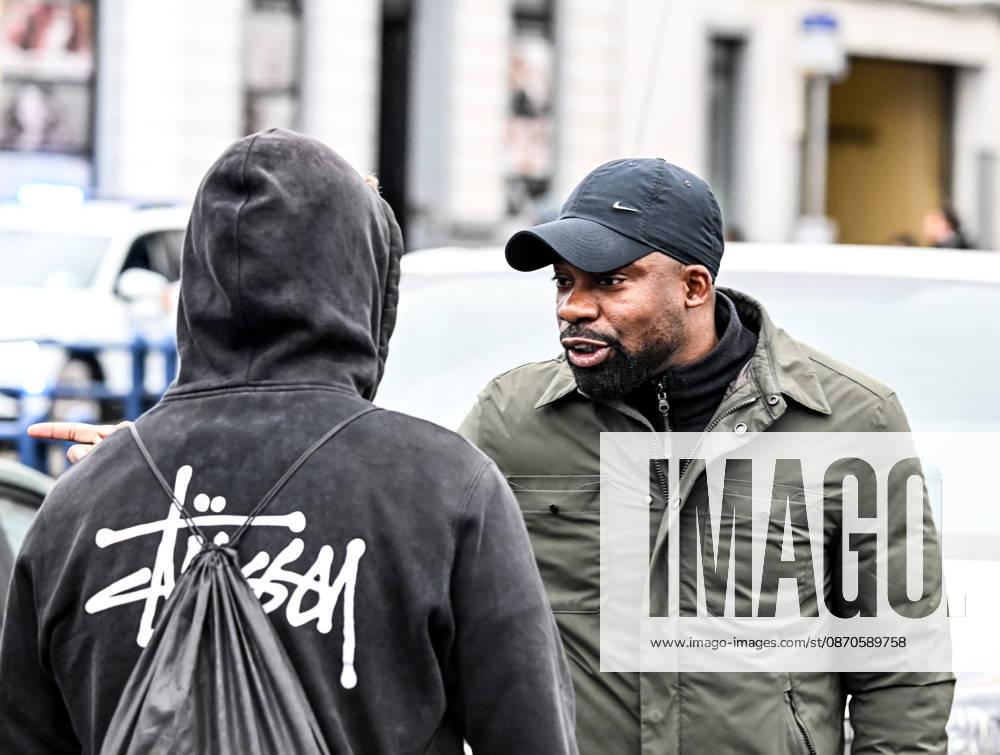 A Black man engages in a heated verbal confrontation with plainclothes police officers during student protests in central Brussels, Belgium, on 24 October 2026. The exchange takes place amid police operations and tensions surrounding demonstrations in the city centre.
