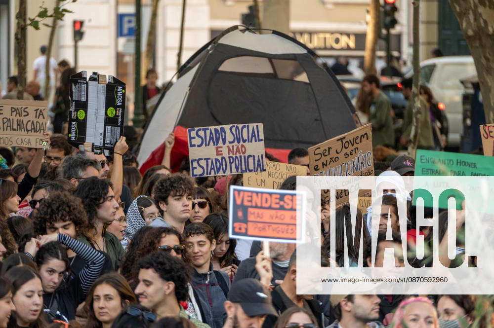 Demonstrators take part in a protest organized by the Acampada de Lisboa housing movement, demanding affordable housing, limits on rising rents and an end to property speculation. The march takes place in central Lisbon, from Marques de Pombal to Rossio Square, following recent police removal of protest tents and the detention of 55 demonstrators during housing protests in the Portuguese capital. Lisbon Portugal - ZUMAr238 20261024_zip_r238_023