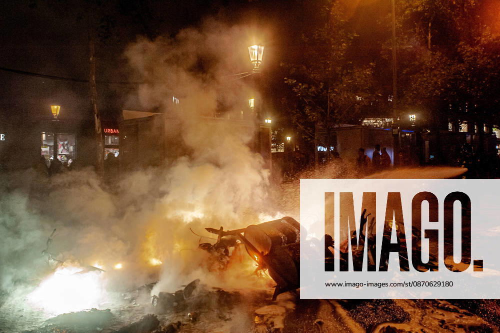 Firefighters extinguish a burning barricade during unrest in central Barcelona. Clashes between demonstrators and police, looting and widespread vandalism were reported across the city centre overnight. Barcelona Spain - ZUMAb137 20261024_fap_b137_002