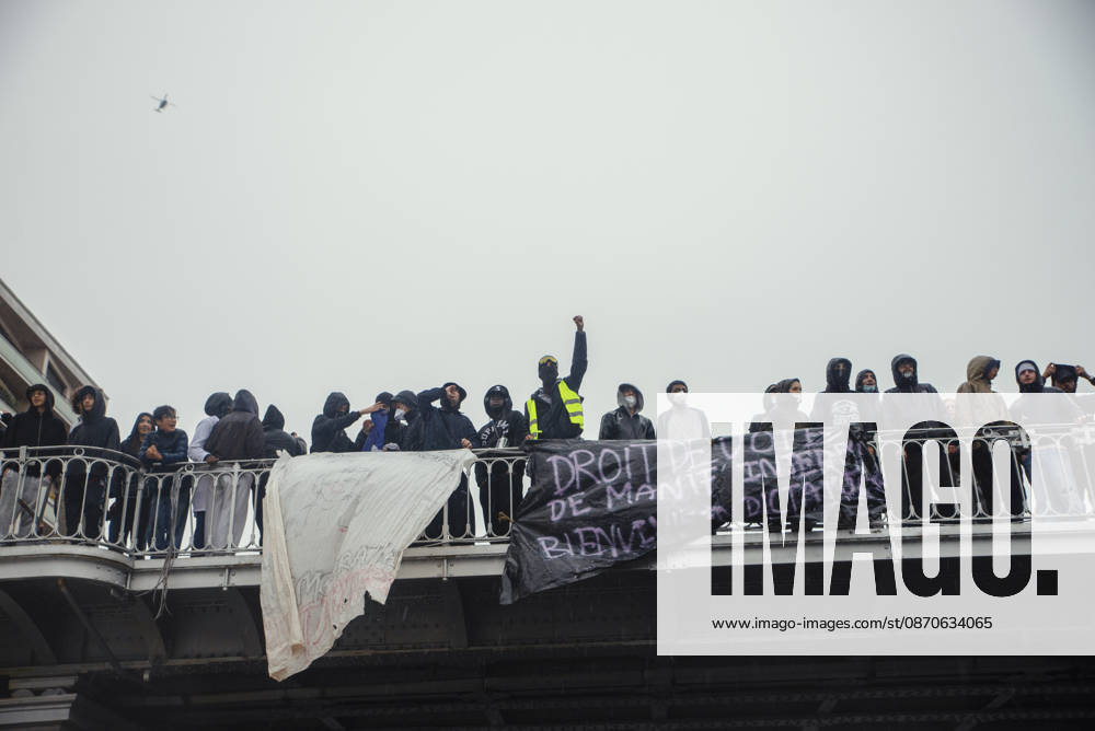 Paris Street Protest Demonstrators gather on a bridge carrying banners in Paris, France on October 24, 2026. Authorities deployed around 70,000 security personnel across France for renewed protests over the cost of living on October 24, after unrest a week earlier saw public buildings vandalized, hundreds of shops looted and about 2,700 people arrested. Paris Ile de France France