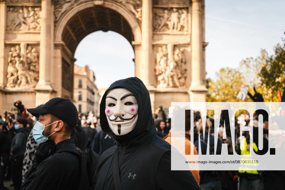 Marseille France Street Protests A demonstrator wearing a Guy Fawkes mask stands near the Arc de Triomphe in Marseille, France on October 24, 2026. Authorities deployed around 70,000 security personnel across France for renewed protests over the cost of living, after unrest a week earlier saw public buildings damaged, hundreds of shops looted and about 2,700 people arrested. Marseille Provence-Alpes-CÃ te France