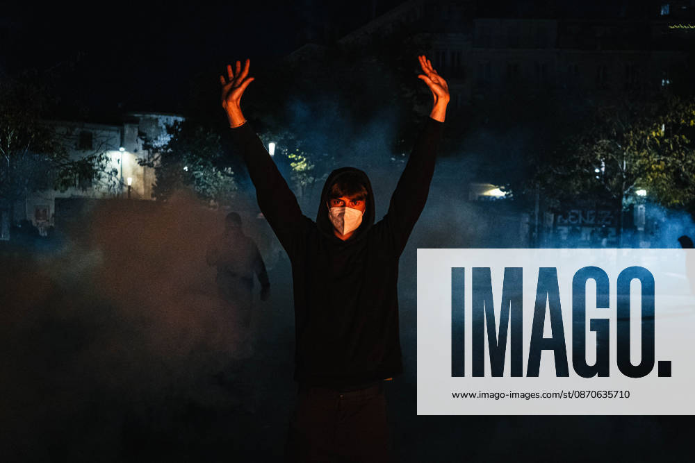 Marseille France Street Protests A demonstrator raises both hands amid smoke during a protest in Marseille, France on October 24, 2026. Authorities deployed around 70,000 security personnel across France for renewed protests over the cost of living, after unrest a week earlier saw public buildings damaged, hundreds of shops looted and about 2,700 people arrested. Marseille Provence-Alpes-CÃ te France