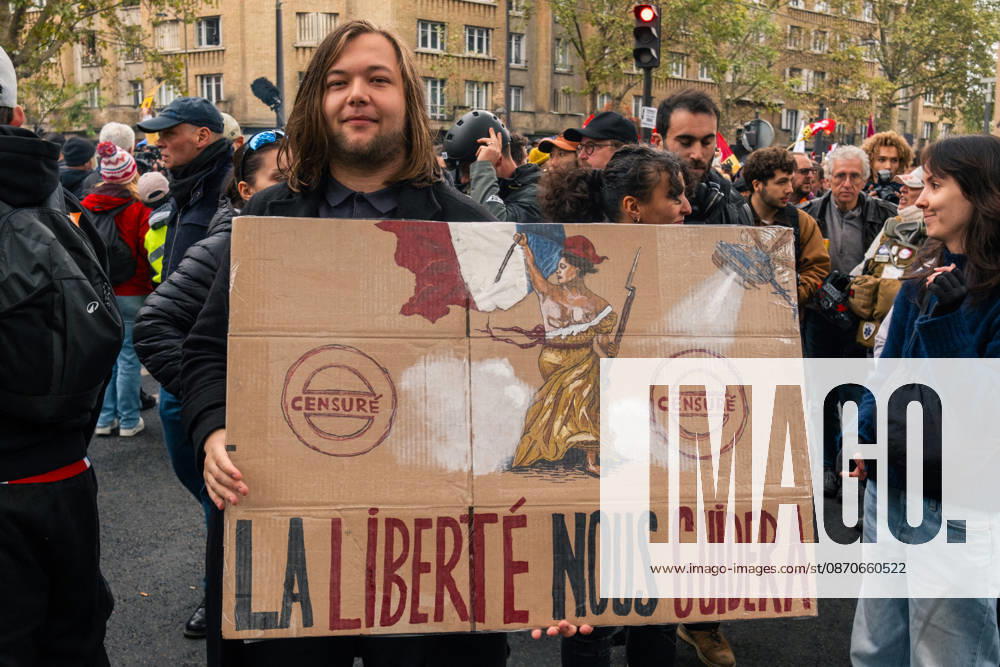 Yellow Vests Protest Act II - Paris Demonstrators carry placards displaying political messages during a march against the rising cost of living and for social justice in Paris, France, on October 24, 2026. The protest follows the boulevards des Maréchaux from Porte d’Italie to Porte de Vincennes, with calls for higher wages and better funding for public services and education. Photo by Jules Bernard ABACAPRESS.COM Paris Île-de-France France