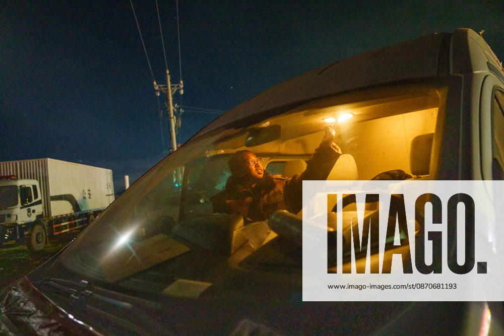 (261025) -- BAQEN, Oct. 25, 2026 -- Du Guoping prepares to rest inside a vehicle after a full day s work at a temporary shelter in Maru Township of Baqen County, Nagqu City, southwest China s Xizang Autonomous Region, Oct. 24, 2026. After a 7.0-magnitude earthquake struck Baqen County in Nagqu, southwest China s Xizang Autonomous Region, on Thursday, Du Guoping, owner of a dumpling restaurant in Xigaze, postponed the opening of his two new restaurants and headed to the disaster zone with his staff. It took only about 10 minutes to make the decision that we would go to Baqen and cook dumplings for earthquake-affected residents, Du said. The team loaded more than 1,500 kilograms of dumplings onto vehicles and set off from Xigaze at mid