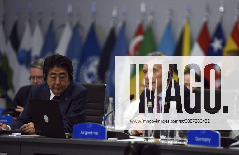 Buenos Aires, Argentina - Argentine President Mauricio Macri, right, address the plenary session on Day Two of the G20 Summit meeting as Japanese Prime Minister Shinzo Abe, left, looks on at the Costa Salguero Center December 1, 2018 in Buenos Aires, Argentina. Buenos Aires Argentina - ZUMAp138 20181201_zaa_p138_046