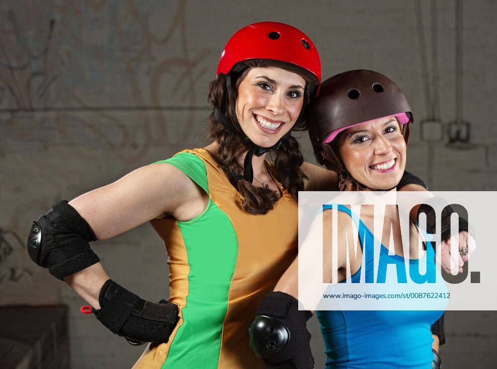 Pair of happy adult roller derby friends model released Symbolfoto