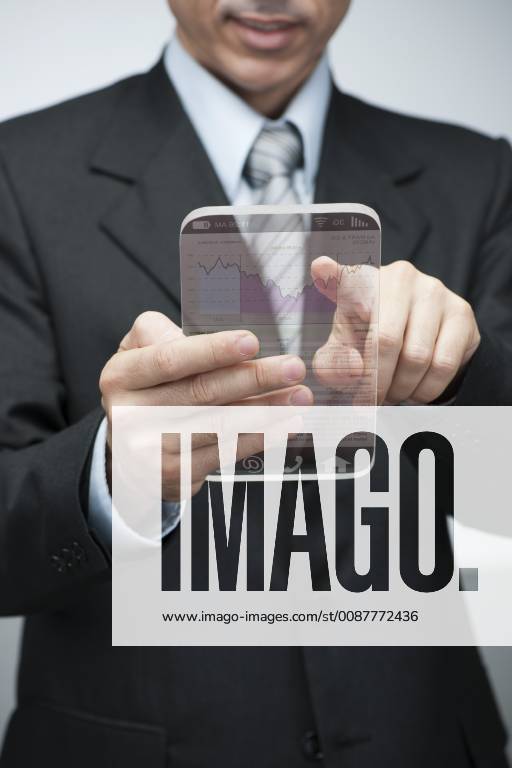 Businessman using advanced digital tablet to access stock market data, cropped
