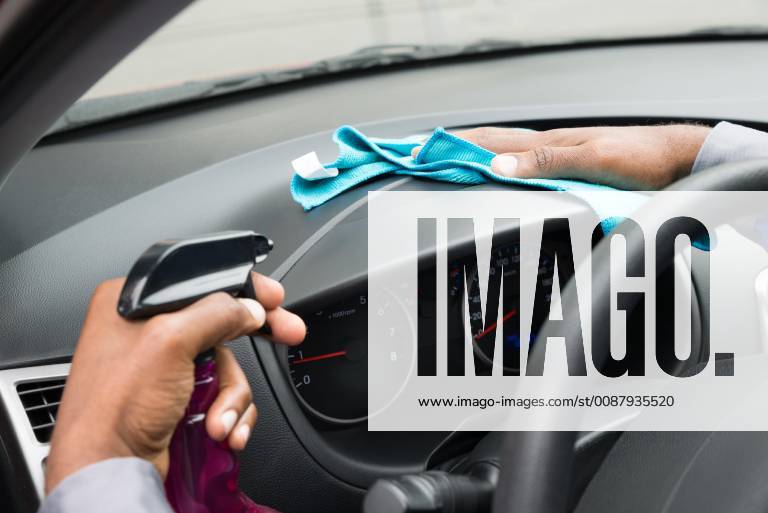 Close-up Of A Worker Wiping Dashboard