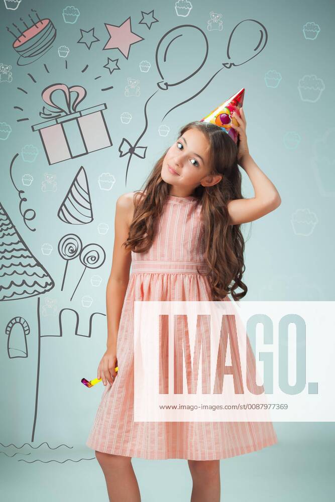 The cute cheerful little girl with festive cap on gray background model released Symbolfoto