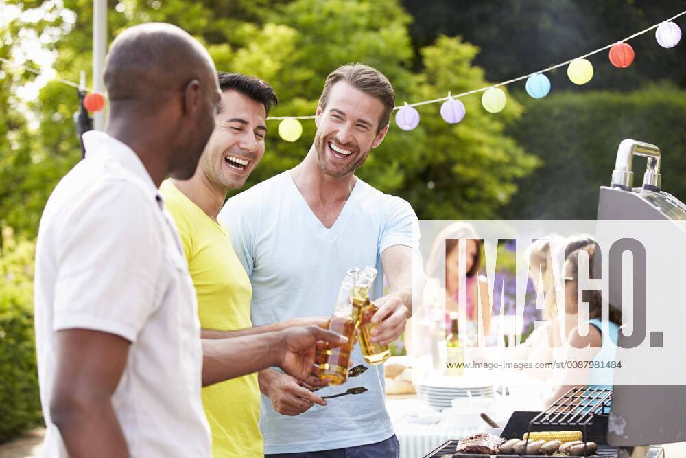 Group Of Men Cooking On Barbeque At Home model released Symbolfoto
