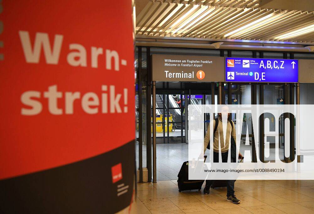 Frankfurt, Streik des Flughafen-Sicherheitspersonals (190115) -- BERLIN, Jan. 15, 2019 -- A passenger passes by a strike warning sign at Frankfurt airport in Frankfurt, Germany, Jan. 15, 2019. Following strikes and severe disruptions of air traffic last week, Germany s second largest workers union ver.di called on security staff at eight German airports to go on strike in the continuing wage dispute, the union announced on Monday. The warning strike will start on Tuesday and affect airports of Frankfurt am Main, Munich, Hamburg, Hanover, Bremen, Leipzig Halle, Dresden and Erfurt.) GERMANY-BERLIN-AIRPORTS-STRIKE LuxYang