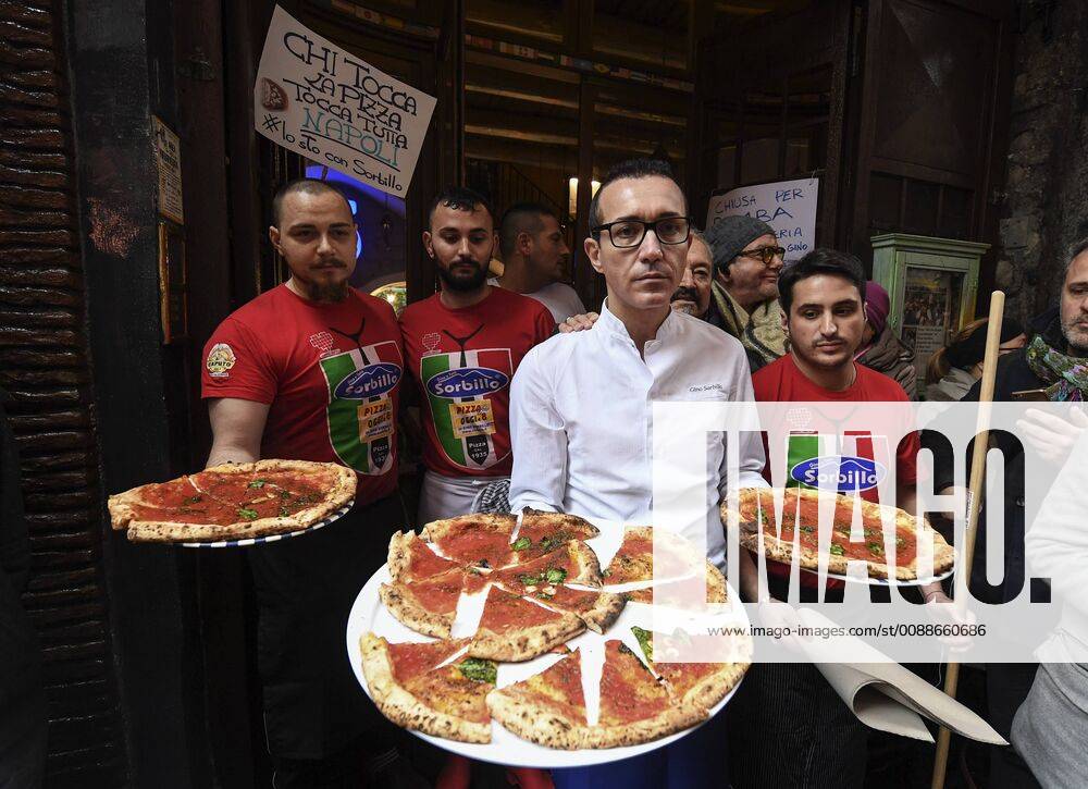 Neapel, Pizzeria Sorbillo öffnet nach Bombenexplosion wieder Gino Sorbillo outside the historic pizzeria in the center of Naples for the reopening of the room after being intimidated by a paper bomb causing damage to his room, gives pizzas to passers-by and tourists approaching. 1 21 2019, Naples, Italy