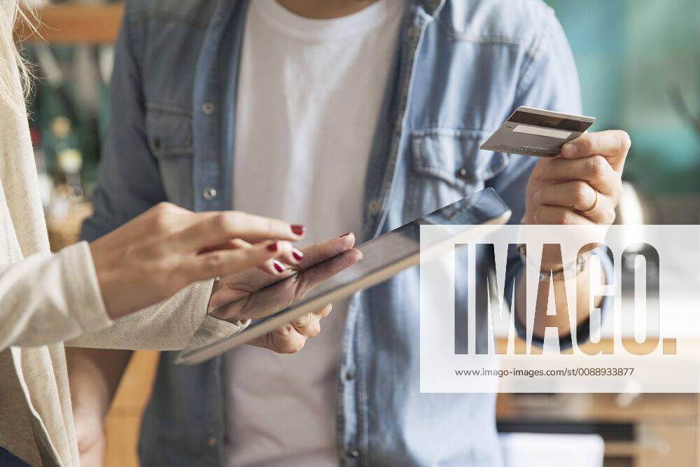 Couple using digital tablet to shop online