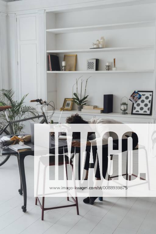 Tired freelancer sleeping on her deak model released Symbolfoto property released BOYF00940