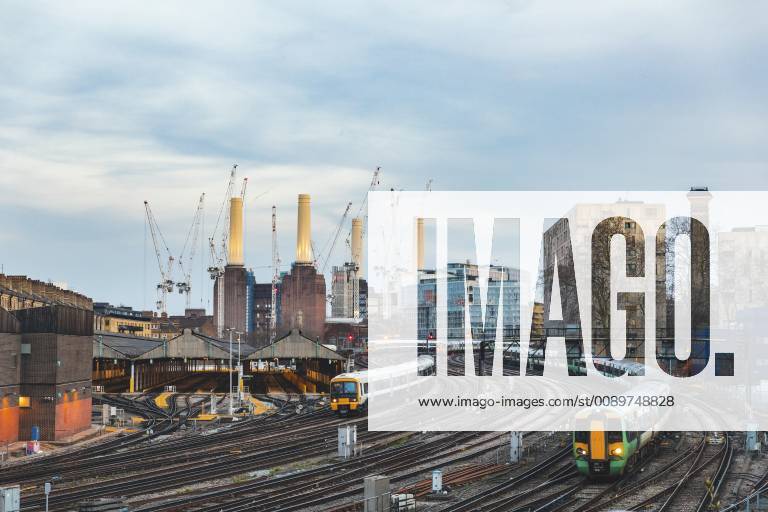 United Kingdom, England, London, view of railtracks and trains in the evening, former Battersea Power Station and cranes in the background WPEF01262