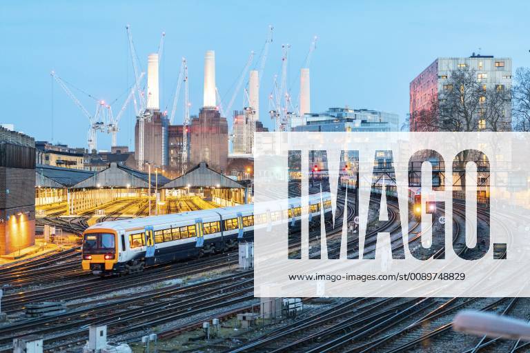 United Kingdom, England, London, view of railtracks and trains in the evening, former Battersea Power Station and cranes in the background WPEF01263