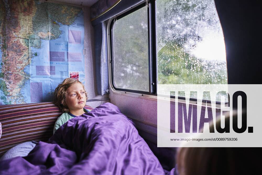Boy in pyjama looking out of window of a camper model released Symbolfoto property released SSCF00163