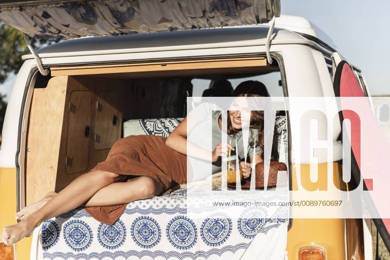 Pretty woman on a road trip with her camper, taking a break, drinking juice model released Symbolfoto UUF16188