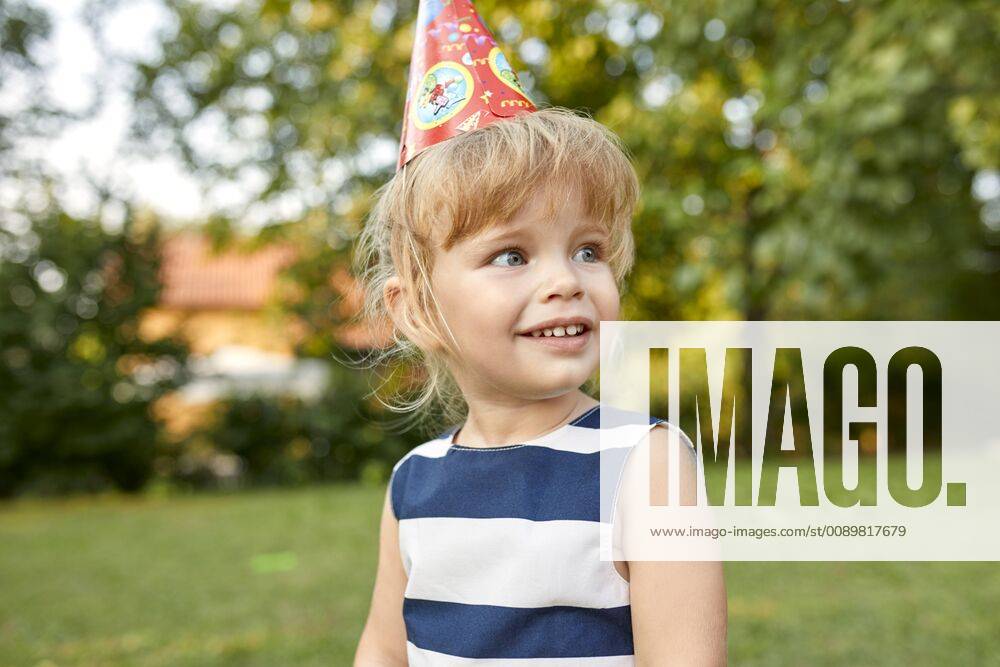 Portrait of little girl on a birthday garden party wearing party hat model released Symbolfoto property released ZEDF01654