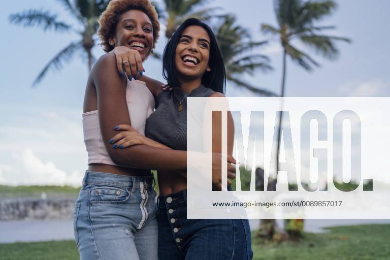 Two happy female friends hugging in a park model released Symbolfoto BOYF01215