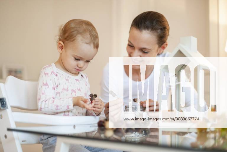 Mother and little daughter tinkering autumnal decorative house at home model released Symbolfoto property released DIGF05589