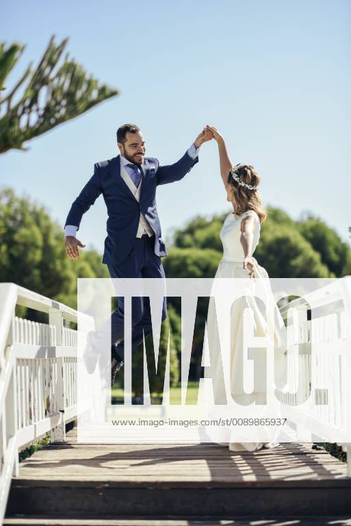 Bridal couple enjoying their wedding day in a park model released Symbolfoto JSMF00572