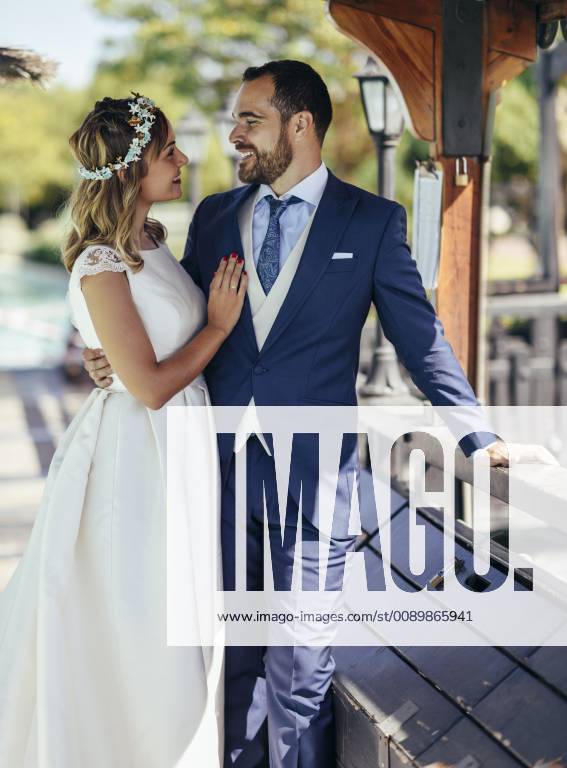 Bridal couple enjoying their wedding day in a park model released Symbolfoto JSMF00577