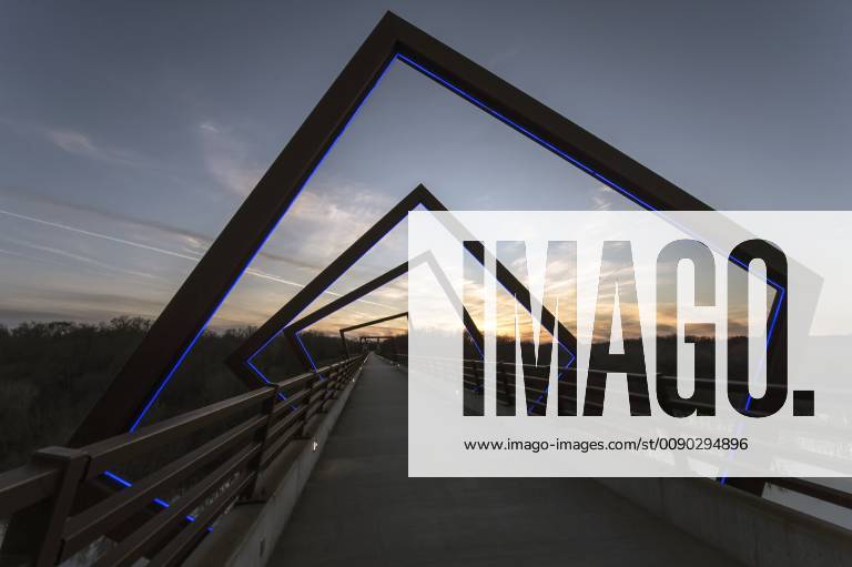 Madrid, Iowa, U.S. - Originally a conduit for rail freight, but now a decomissioned railroad line, the High Trestle Trail Bridge is part of the 25-mile Trestle Trail path for bikers, hikers and horseback riders. The artistic, spiral steel frames springing up from the road bed are a nod to the shape of the timbers placed in former central Iowa coal mines. Madrid U.S. - ZUMAce6_ 20190322_zaf_ce6_019
