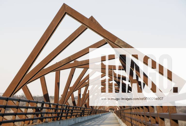Madrid, Iowa, U.S. - Originally a conduit for rail freight, but now a decomissioned railroad line, the High Trestle Trail Bridge is part of the 25-mile Trestle Trail path for bikers, hikers and horseback riders. The artistic, spiral steel frames springing up from the road bed are a nod to the shape of the timbers placed in former central Iowa coal mines. Madrid U.S. - ZUMAce6_ 20190322_zaf_ce6_009