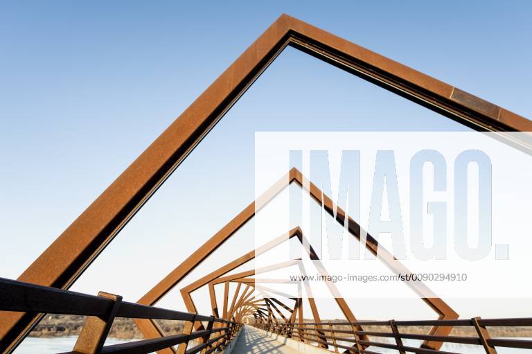 Madrid, Iowa, U.S. - Originally a conduit for rail freight, but now a decomissioned railroad line, the High Trestle Trail Bridge is part of the 25-mile Trestle Trail path for bikers, hikers and horseback riders. The artistic, spiral steel frames springing up from the road bed are a nod to the shape of the timbers placed in former central Iowa coal mines. Madrid U.S. - ZUMAce6_ 20190322_zaf_ce6_012