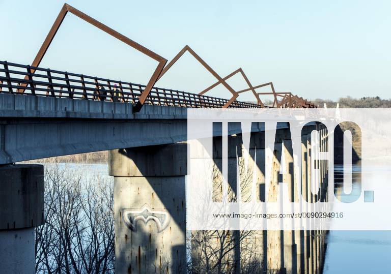 Madrid, Iowa, U.S. - Originally a conduit for rail freight, but now a decomissioned railroad line, the High Trestle Trail Bridge is part of the 25-mile Trestle Trail path for bikers, hikers and horseback riders. The artistic, spiral steel frames springing up from the road bed are a nod to the shape of the timbers placed in former central Iowa coal mines. Madrid U.S. - ZUMAce6_ 20190322_zaf_ce6_006