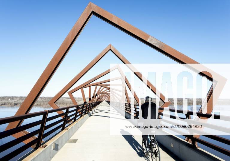 Madrid, Iowa, U.S. - Originally a conduit for rail freight, but now a decomissioned railroad line, the High Trestle Trail Bridge is part of the 25-mile Trestle Trail path for bikers, hikers and horseback riders. The artistic, spiral steel frames springing up from the road bed are a nod to the shape of the timbers placed in former central Iowa coal mines. Madrid U.S. - ZUMAce6_ 20190322_zaf_ce6_002