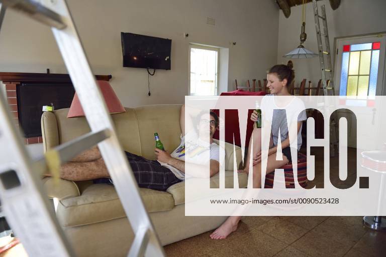 Happy young couple having a break from renovating their home model released Symbolfoto property released ECPF00200