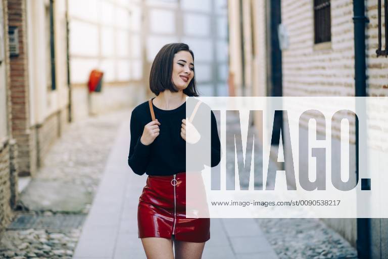 Portrait of young woman wearing red patent leather skirt with zipper model released Symbolfoto JSMF00741