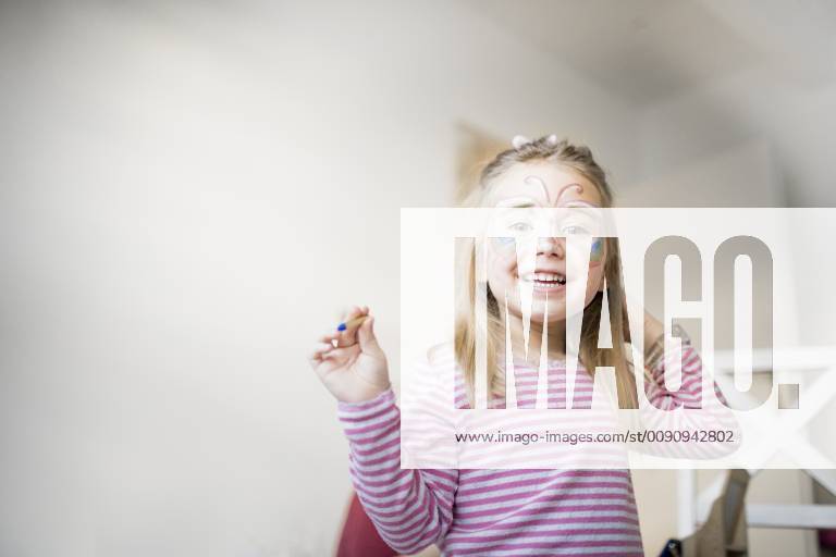 Portrait of smiling little girl made up as butterfly model released Symbolfoto property released KMKF00791