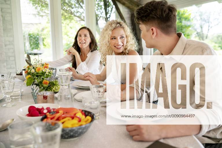 Young man and woman flirting on a family celebration model released Symbolfoto property released PESF01272