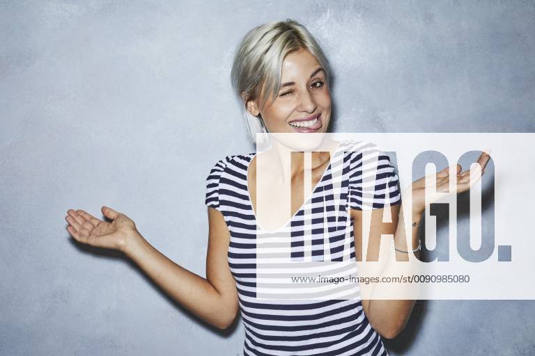 Cheaky young woman making funny faces model released Symbolfoto PNEF01139