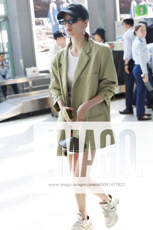 Chinese actress Zhong Chuxi arrives at the Shanghai Hongqiao International Airport before departure in Shanghai, China, 23 May 2019. Handbag: Louis Vuitton Zhong Chuxi arrives at Shanghai airport before departure bjl9767092