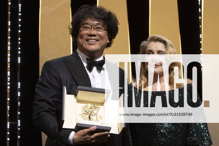 Bong Joon-ho with his Palme d Or (Golden Palm) for the movie Parasite Gisaengchung and Catherine Deneuve at the award ceremony during the 72nd Cannes Film Festival at the Palais des Festivals on May 25, 2019 in Cannes, France