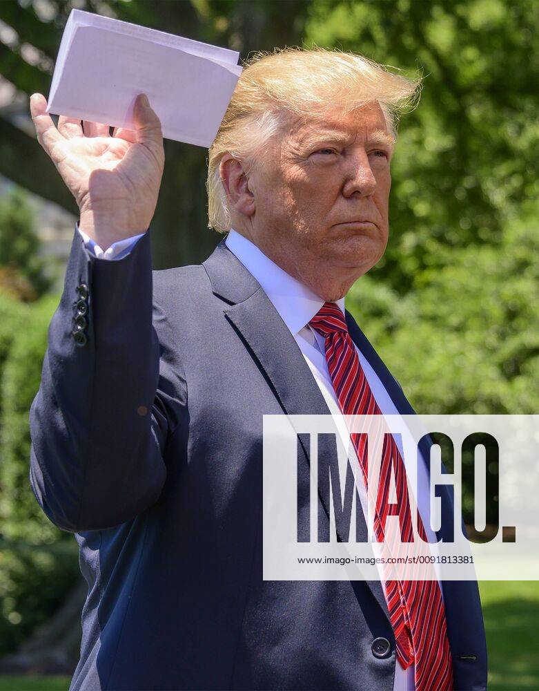 United States President DONALD J. TRUMP shows what he says is a page of the agreement with Mexico as he takes questions from reporters as he prepares to depart the South Lawn of the White House in Washington, DC for a trip to Iowa. He will return this evening Washington U.S. - ZUMAs152 20190611_zaa_s152_002